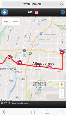 Image of the bus-tracking map for the Where's My Bus application showing route 766 in red on the top, with a road map showing 3 red bus icons on a red highlighted road with arrows pointing in their direction of travel. Below the map it has the words 6 active busses and the time. The URL wmb.unm.edu is seen above the map.