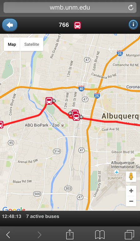 Image of the bus-tracking map for the Where's My Bus application showing route 766 in red on the top, with a road map showing 3 red bus icons on a red highlighted road with arrows pointing in their direction of travel. Below the map it has the words 7 busses and the time. The URL wmb.unm.edu is seen above the map.