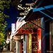 A photo by Nathaniel Paolinelli  of Route 66 at night featuring businesses.