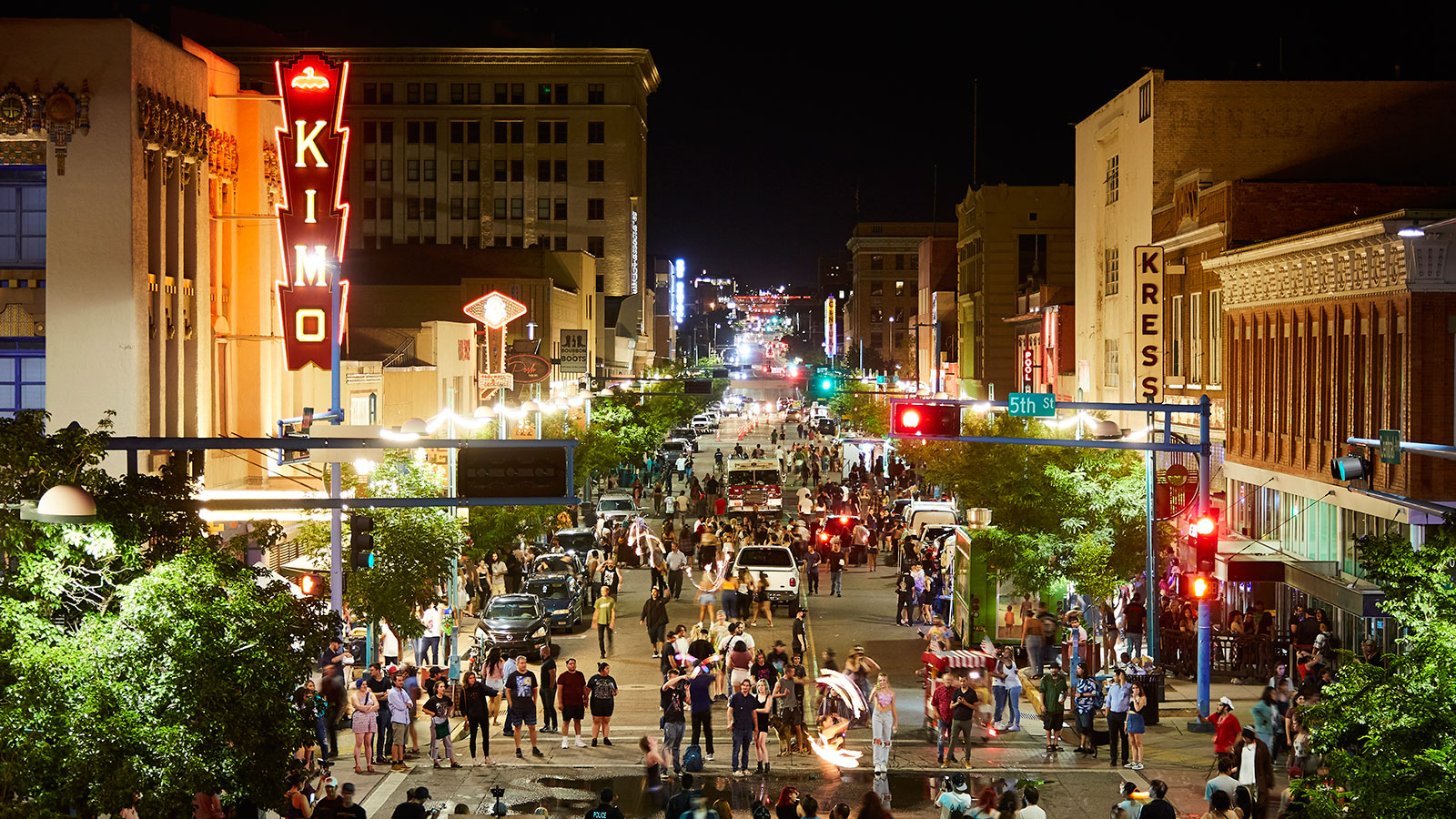 Night time scene of crowds on Central in front of the KiMo Theater