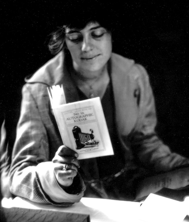 Daphne Cobb reading a Kodak manual , ca. 1920