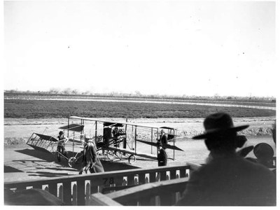 Charles Walsh's Curtiss Biplane at the Territorial Fair Race Track (Speed Ring), 1911. Territorial Fair Grounds, Old Town, Albuquerque. The Albuquerque Museum Photoarchives. Gift of George Pearl, 1978.1.13.