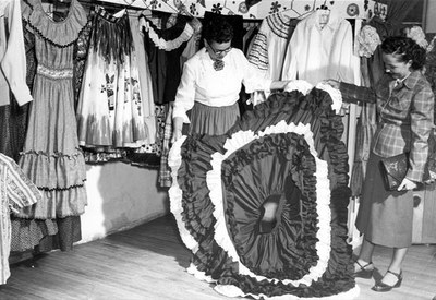 Fiesta dresses at the Old Town Costume Shop, 1951.  Photographer: Harvey Caplin, Albuquerque Progress Collection, 1980.186.555.