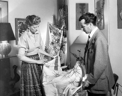 Designer Robert Klein showing fabric to Peggy Hooton in Old Town, 1951.  Albuquerque Progress Collection, 1980.186.556