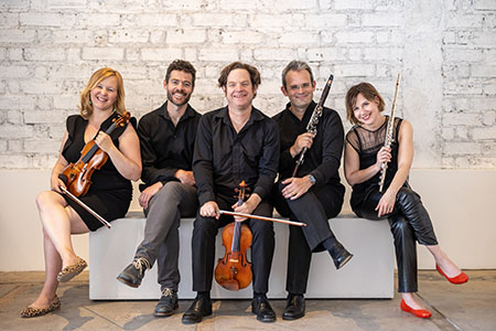 Five members of Chatter Ensemble seated with their instruments.