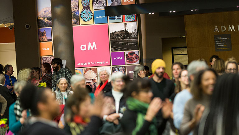 A crowd in the Albuquerque Museum lobby