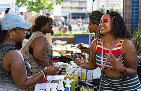 Portrait of Women of color at an outdoor event.b