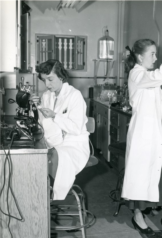 Two female Sandia National Laboratories employees work in a lab.