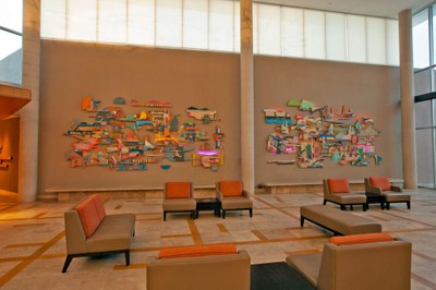 Karl Hofmann, Shapeshifters An artwork composed of an array of organic, wall mounted pieces of painted wood with bright-colored LEDs shining from behind, installed in the lobby of the Albuquerque Museum.