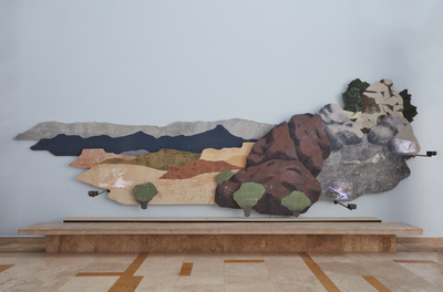 A detail of the right panel of Haunted, by artist Nicola López, an installation mounted on the wall of the Albuquerque Museum lobby. This panel depicts one half of a desert landscape. Multiple small projectors are mounted to the front of the panel, projecting videos onto the landscape.