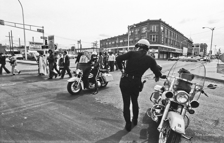 Anthony Louderbough, Police on Motorcycles Watch Demonstrators March along Central Avenue