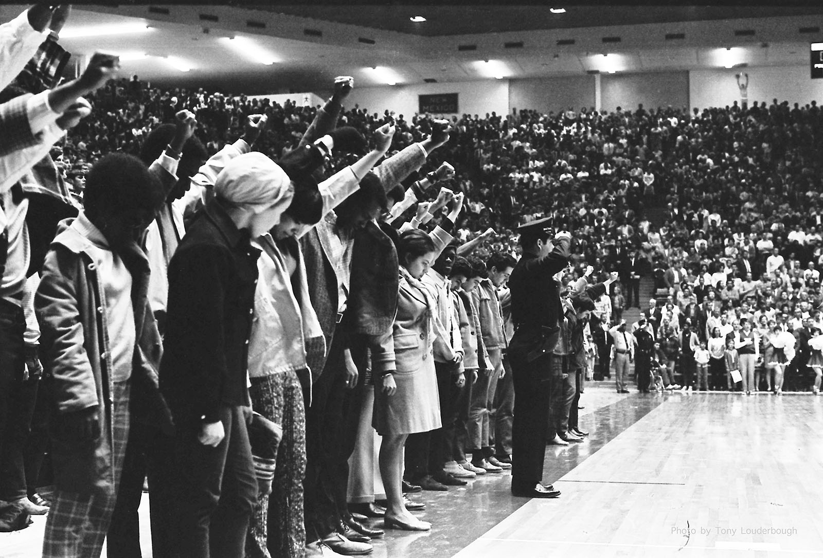 Anthony Louderbough, University of New Mexico Students Give Black Power Salute during the US National Anthem
