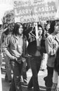 Anthony Louderbough, Demonstrator Holds Sign Reading, “Sitting Bull, Larry Casuse, Crazy Horse”