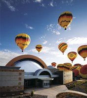 The Anderson-Abruzzo Albuquerque International Balloon Museum flanked with balloons. 