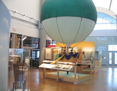 The Channel Crossing exhibit, part of the Early Ballooning exhibition, which features a small teal balloon.
