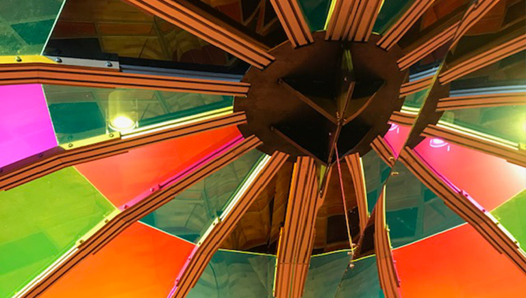 A close-up of a colorful overhead dome of one of the exhibits in this exhibition.