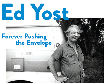 A black and white photo of balloonist Ed Yost standing in front of the back of a white van. He's wearing overalls and has a pipe in his mouth. Text on the image: Ed Yoast, Forever Pushing the Envelope.