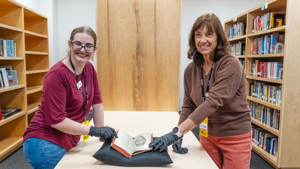 Exterior front of the Balloon Museum with balloons flying over.