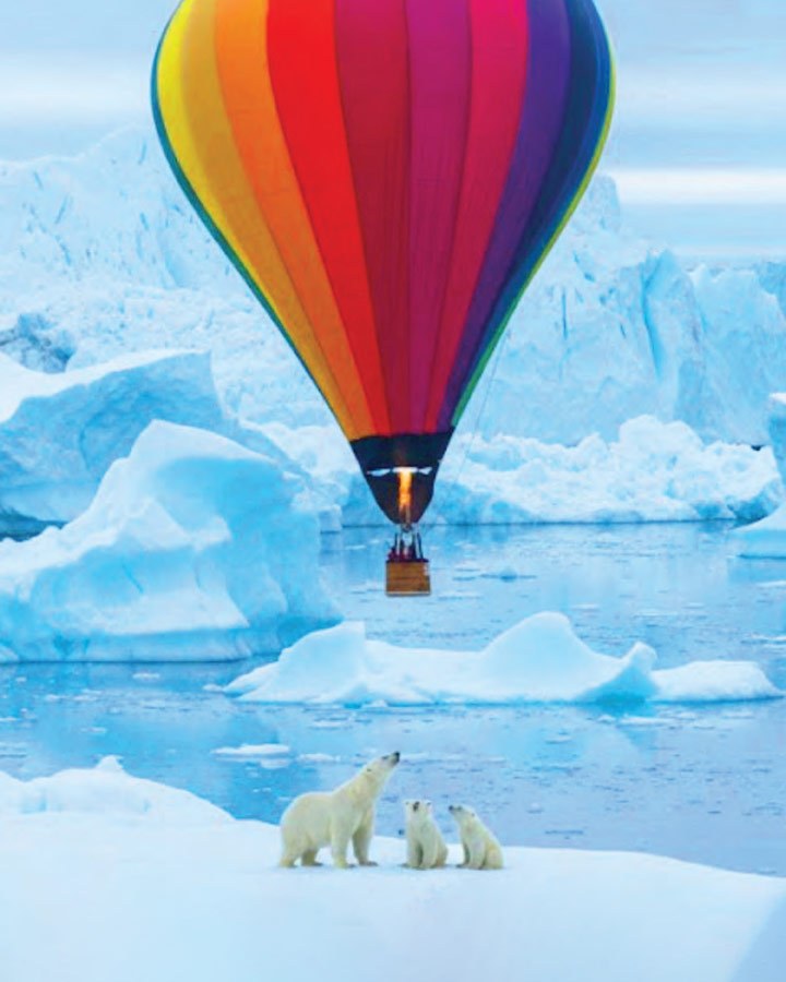 The expedition's team flies over polar bears in their hot air balloon during their training.