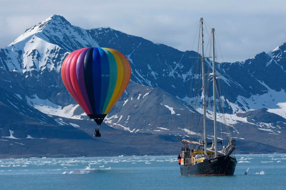 BM-Polar-Expedition(LOG-6-21-26)-web45a Polar Expedition team flying their balloon over a body of water alongside their ship The Meander.