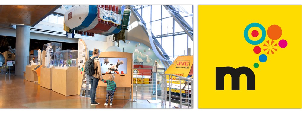 Albuquerque City officials and Balloon Museum leadership use gold painted shovels to break ground as a rainbow of color smoke explodes above them. Alongside them local parents with their kids also hold shovels to break ground at the Outdoor Balloon Adventure site.