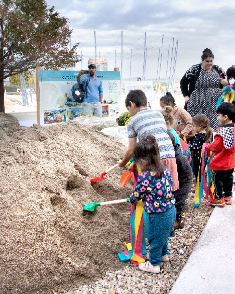 Kids join in the groundbreaking ceremony at for Outdoor Balloon Adventure divider line that is the Balloon Museum's pink color