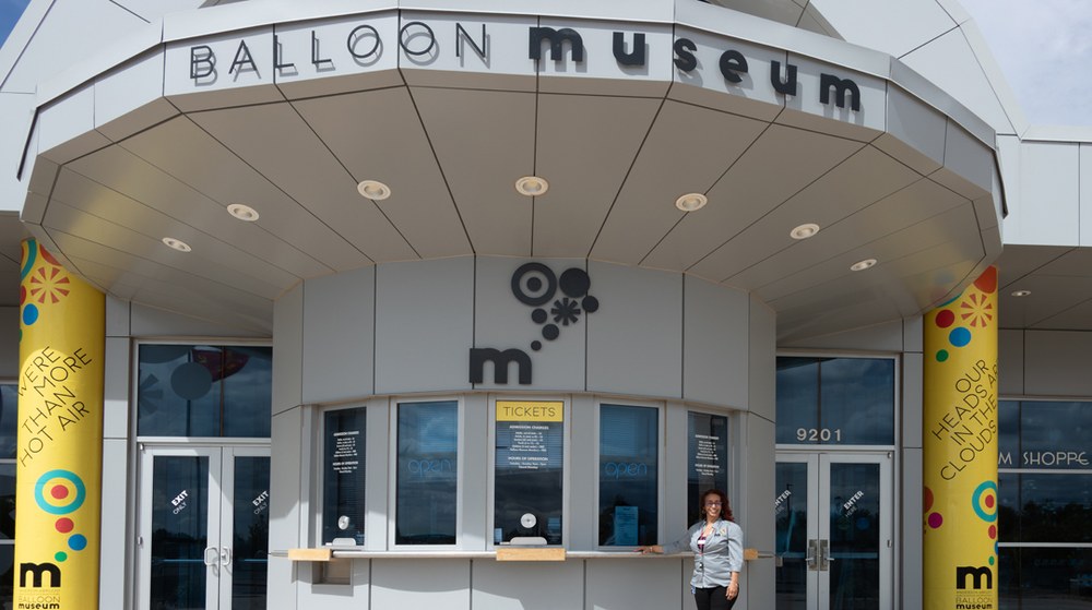 BM-MG_0184-web100.jpg Balloon Museum staff member welcomes visitors at the ticket booth.
