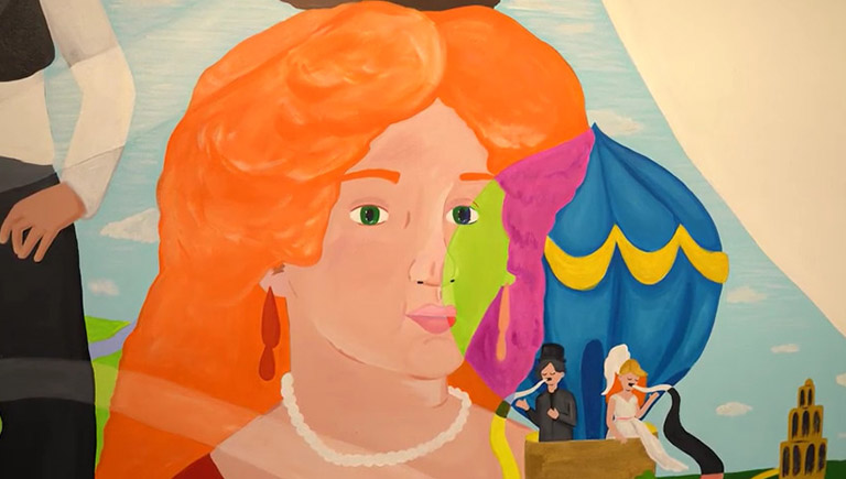 A close up of a small section of a large painting featuring women aviators. This section features a red-headed woman with long dangle earrings and a pearl necklace. In the background behind her are two people in a blue hot air balloon.
