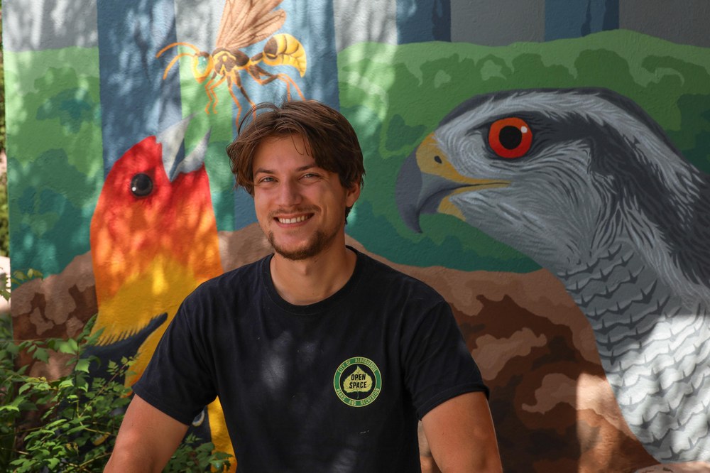 Donny Kelley-Currens pictured alongside his artwork.