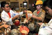 caption:Camp BioPark Students help prepare animal enrichment.