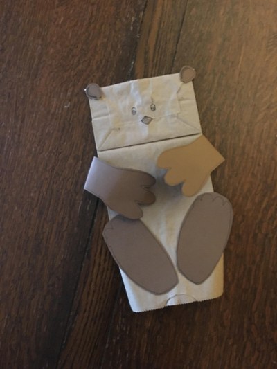 A paper bag puppet craft project of a river otter.