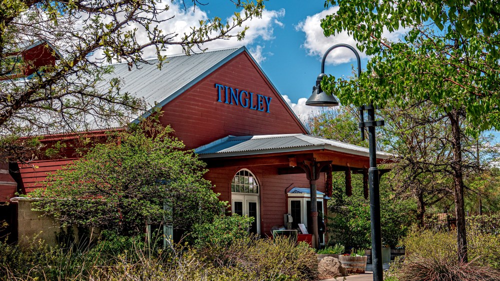 Tingley Station new header A photo of the Tingley Station flanked by lush foliage on a sunny summer day