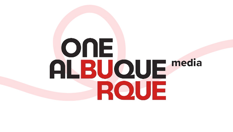 The One Albuquerque Media logo. There is a faded red line design in the background that forms one loop right behind the logo.