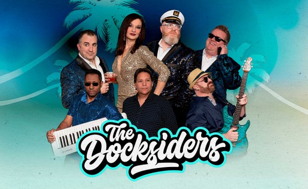 Six band members posing with musical instruments and drinks against a tropical backdrop with palm trees and ocean waves.
