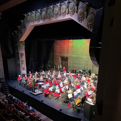 An orchestra performing on the stage of Kimo Theatre.