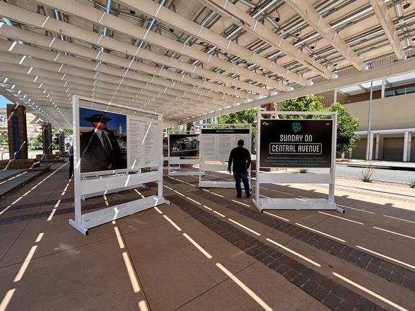 The Sunday on Central Avenue exhibition, an open-air art exhibit with metal stands featuring portrait photos of people alongside their poetry.