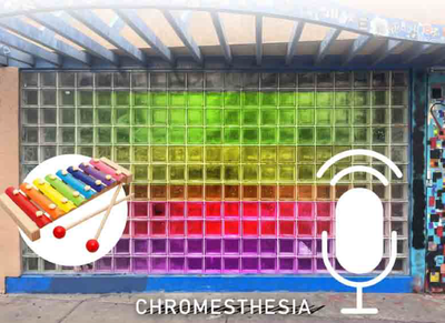 Glass brick wall with multiple color lights and icons of a microphone and a colorful xylophone.