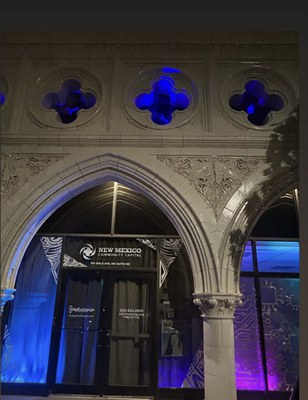 Blue and purple light installation in the alcoves of a building. 