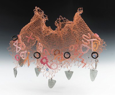 Knitted copper wire sculpture with glass shapes hanging down from the wire. 