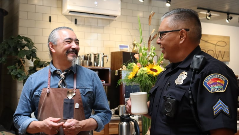 Police officer has coffee with community member