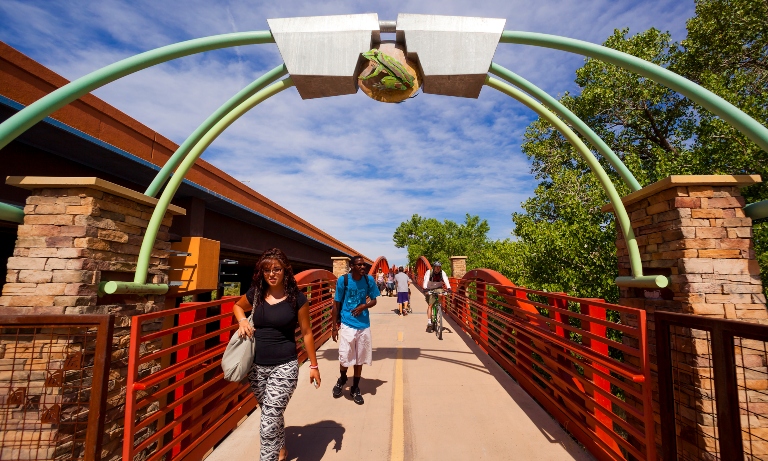 Pedestrians crossing the Rio Grande River via a bridge