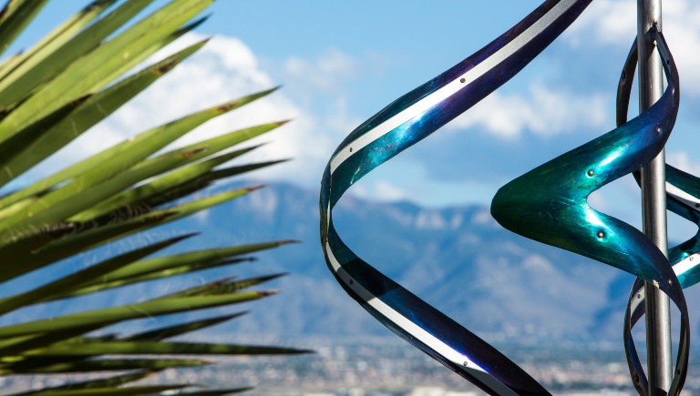 Yucca and a metal art with the sandia mountains in the background