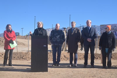 Governor Michelle Lujan Grisham speaking surrounded by City Councilor Brook Bassan, Mayor Tim Keller, and State and County leaders.