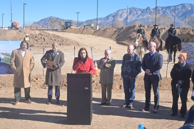 City Councilor Brook Bassan surrounded by Mayor Tim Keller and State and County leaders.