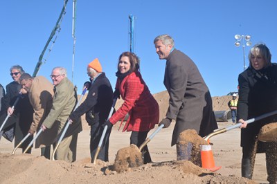 City Councilor Brook Bassan, Mayor Tim Keller, and Governor Michelle Lujan Grisham with other leaders, shoveling dirt.