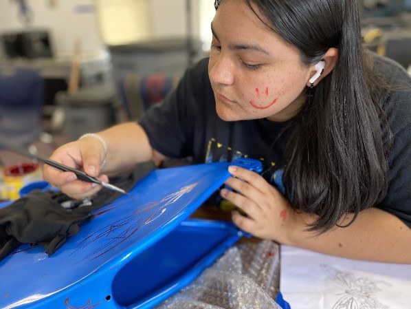 Española Lowrider Bike Club student adds fine details to her Lowrider creation