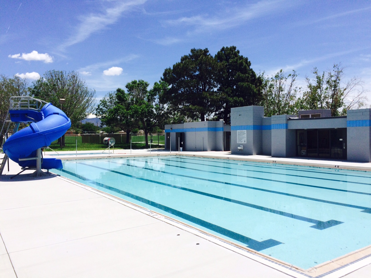 A photo of an outdoor swimming pool on bright, sunny day.