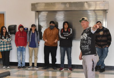 Rob Vanderslice, Project Coordinator, speaking to students standing against the wall at the launch of the Duke City Leadership Lowrider Bike Club on March 1, 2023.