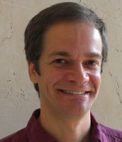 A headshot of Jimmy Carleton in a red shirt.