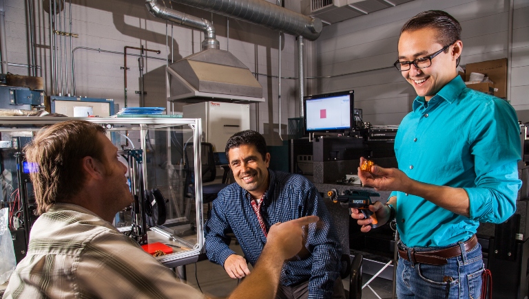 Three workers at the Air Force Research Lab